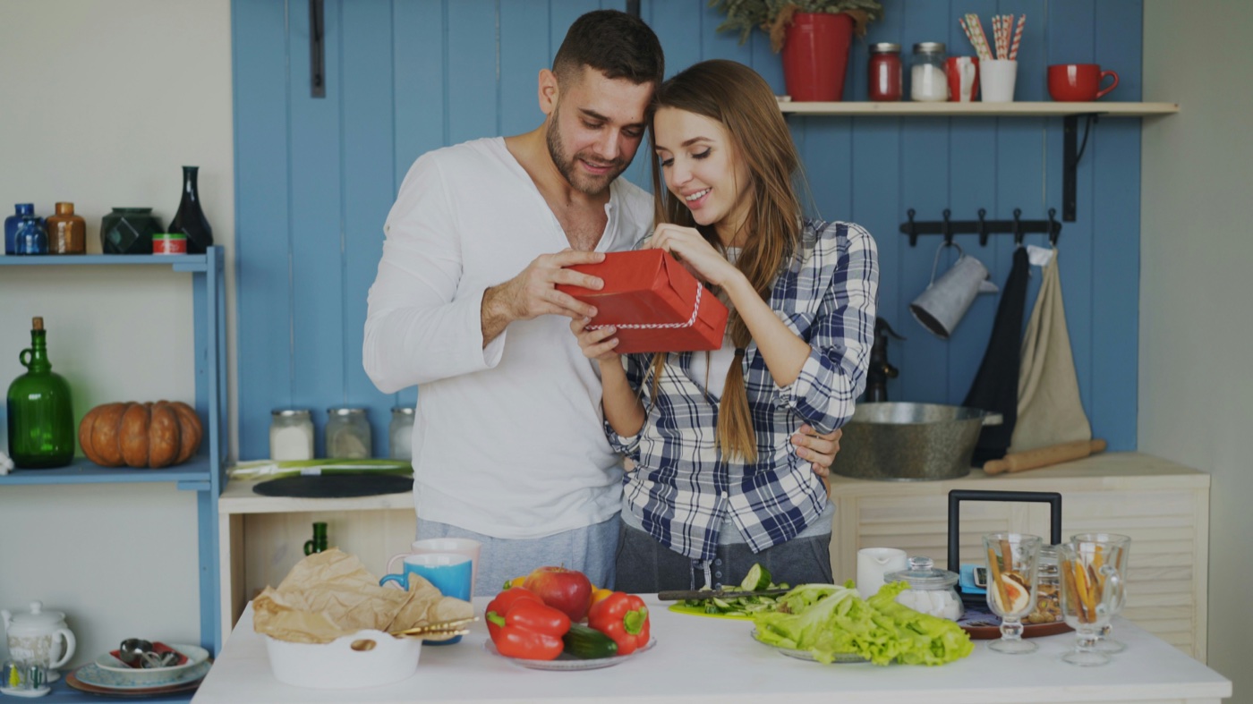 A couple sharing a wrapped gift